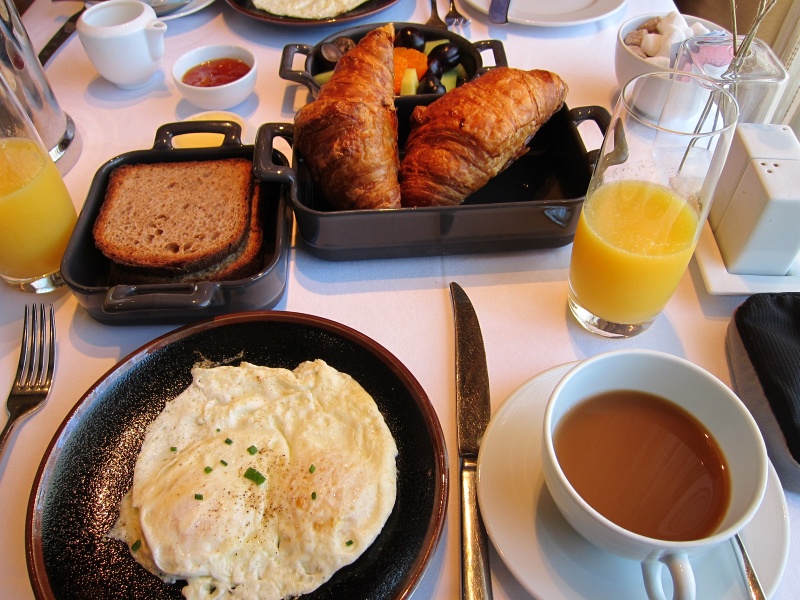 IMG_3868.JPG - Next day's breakfast - eggs, croissant, fruit plate, coffee and orange juice