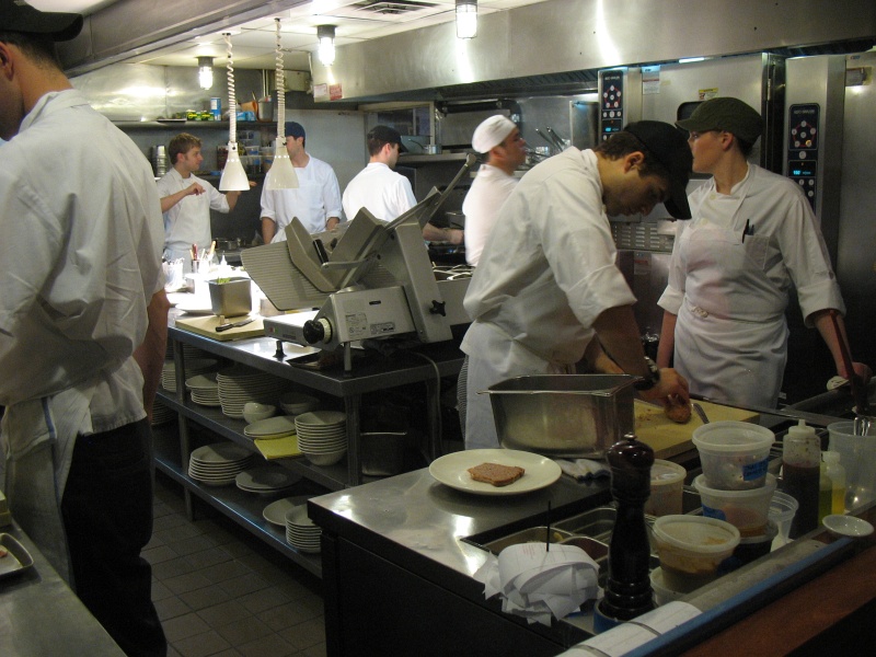 IMG_4920.JPG - The kitchen at Momofuku Ssam.  The guy in the white hat might be chef David Chang.