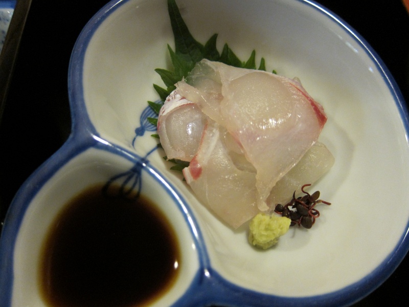 IMG_0230.JPG - Hirame (flounder), which we had a lot on the trip because it's in season during the winter.  The meat has a clean, chewy texture.  It rests on a shiso leaf, with a morsel of ground wasabi and shiso sprouts