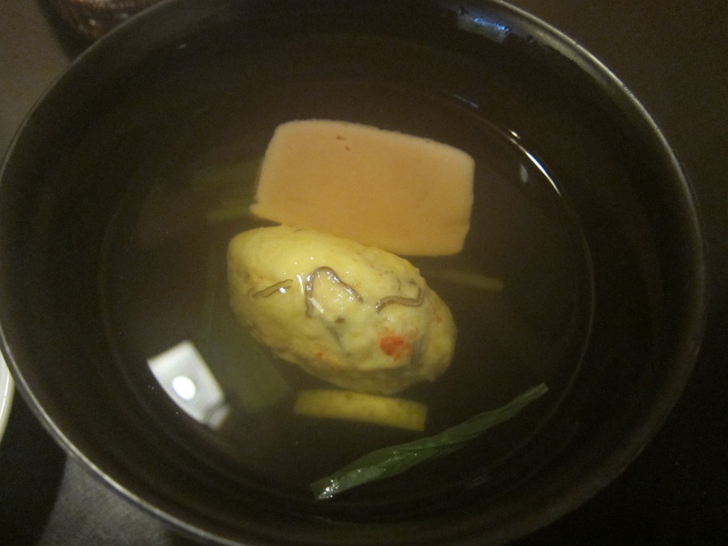 IMG_0235.JPG - Dashi broth with incredibly intense flavor, kombu (kelp), a vegetable/fish/mushroom ball, a soft mochi, and a sliver of aromatic yuzu.