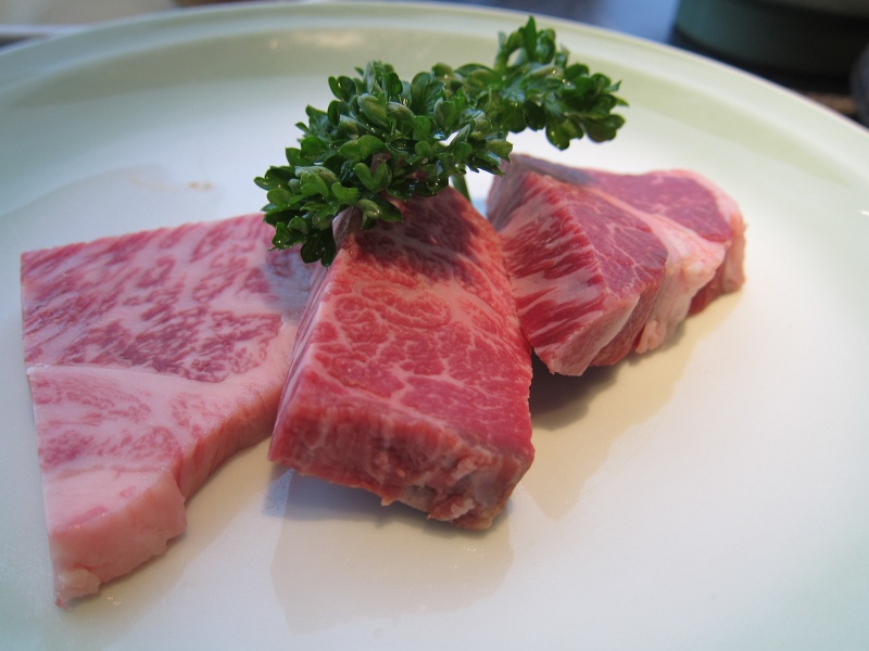 IMG_0352.JPG - We chose the medium grade wagyu, which was 5000 yen for 1 set.  You only see 3 pieces because 2 of them were already in the pan.  Notice the incredible fat marbling...