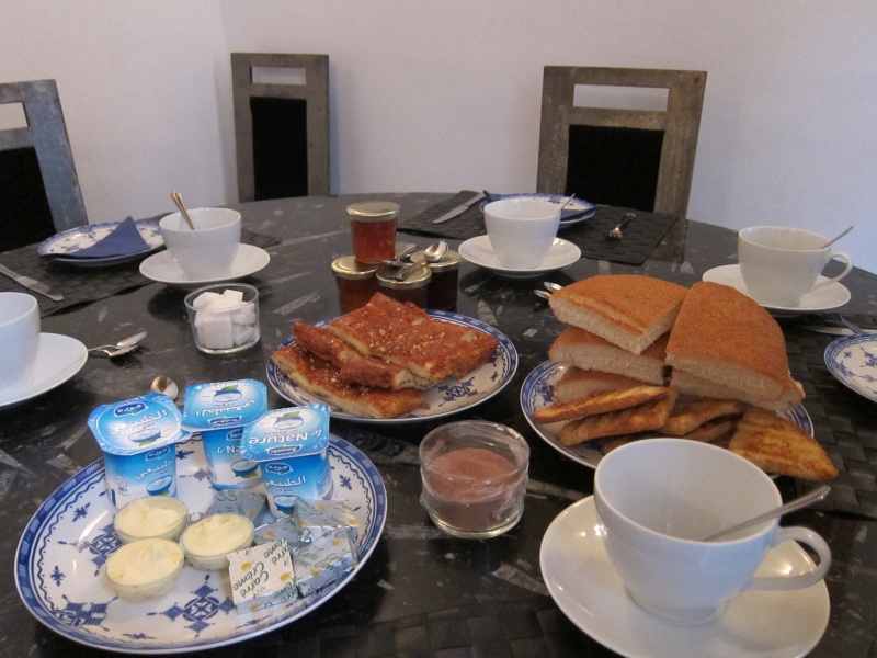IMG_1218.JPG - Breakfast next morning at our riad (Dar Faracha) - various breads, jam, yogurt, bought from hanuts (convenience shops)