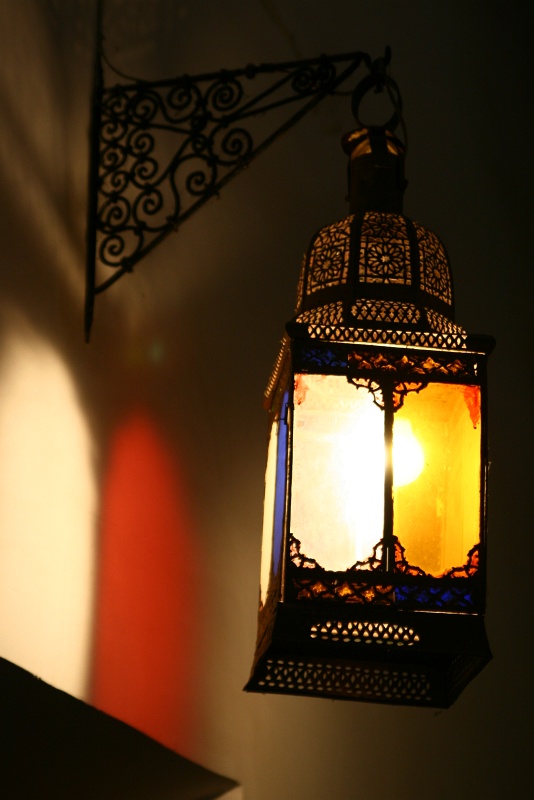 IMG_8479.JPG - Finely crafted Moroccan lantern inside Bahia, casting a warm glow on the wall