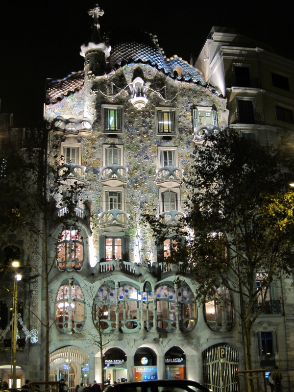 IMG_0047.JPG - Casa Batll, a Modernista facade along Passeig de Grcia in the Eixample neighborhood built in 1877.  Designed by Antoni Gaud, the structure uses natural shapes like tibia and shells and is covered by a mosaic of broken ceramic tiles.  The humpback roofline suggests a dragon's back, as Gaud based the design on the legend of St. Jordi (George) slayin the dragon.