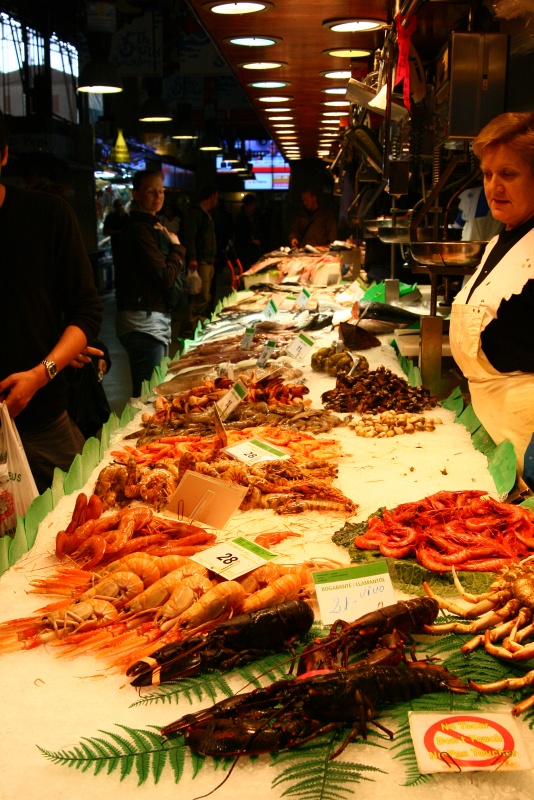 IMG_6068.JPG - Fresh seafood on display inside La Boqueria, a lively produce market off La Rambla that has existed in some form since 1200.  La Rambla used to be the drainage ditch outside the city, so this market was just outside the walled city's gate.  See these delicacies cooked  here .