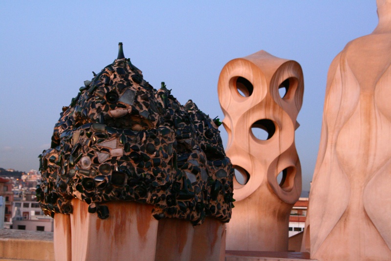 IMG_6223.JPG - More fanciful chimneys, including one covered by shards from broken wine bottles